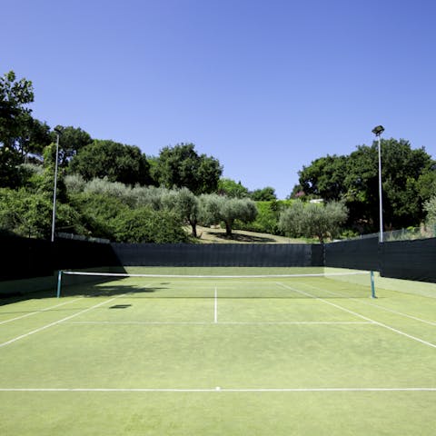 Practise your serve on the tennis court