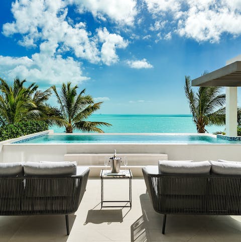 Admire views of the Caribbean Sea from the poolside loungers