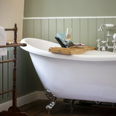 Relax after a long day in the elegant claw-foot bathtub
