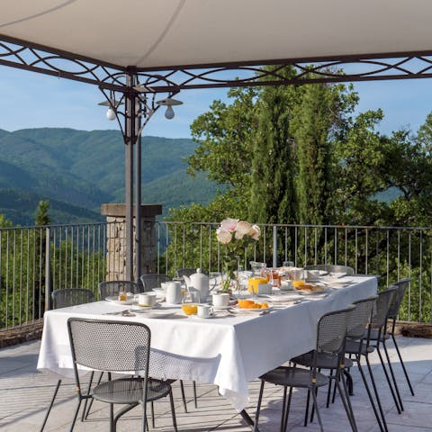 Gather for an alfresco dinner in the shade of the wrought-iron gazebo