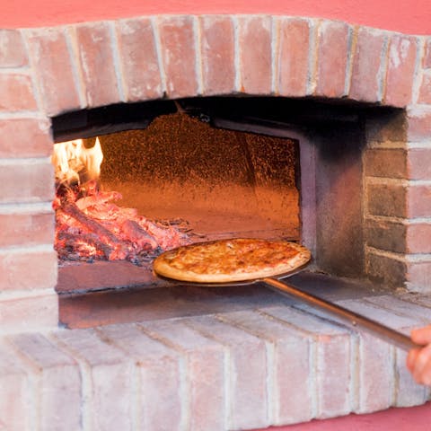 Enjoy freshly-made pizza straight from the brick oven, fired up by your host twice a week
