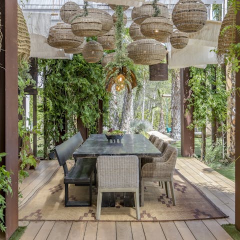 Enjoy atmospheric evenings around the outdoor dining table as the sun sets