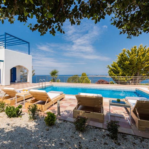 Kick back and relax on sun loungers with a view of the deep blue Mediterranean Sea