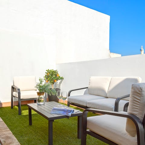 Relax on the sunny communal terrace, a glass of Spanish wine in hand