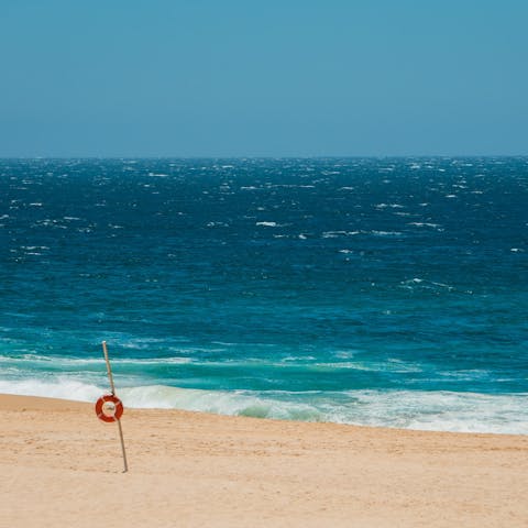 Drive down to Cabo San Lucas and stroll along the sandy Cabo Beach