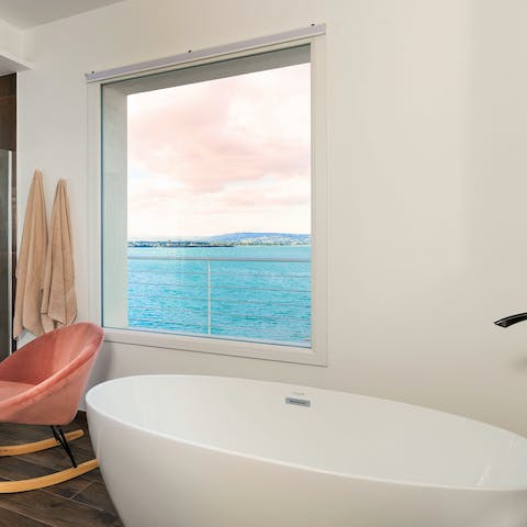 Soak in the deep tub while looking out at the Mediterranean Sea