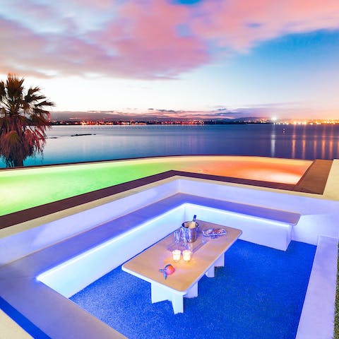 Have a few drinks in the Ibiza-style conversation pit while the pool illuminates in neon