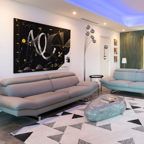 Take a moment to relax on the sumptuous sofa, surrounded by incredible modern artwork