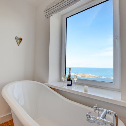 Relax with a glass of fizz in the roll-top bathtub and take in the sea vistas at sunset