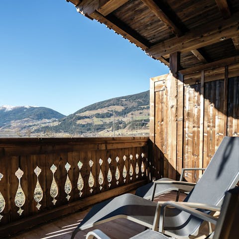 Step out onto the balcony and gaze out at the hilly landscape