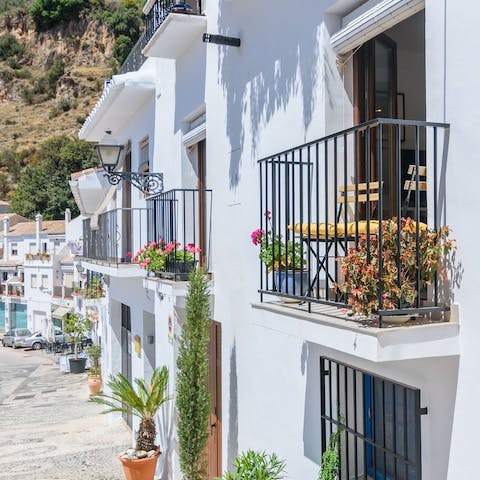 Sit on your sunny balcony with a glass of wine overlooking the quaint street