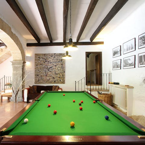 Enjoy the click of snooker balls at the full-size table inside