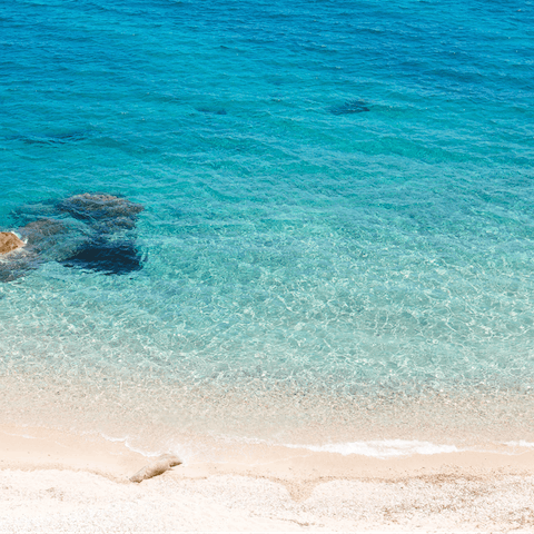 Dive into the crystal clear waters of the Aegean Sea – the nearest beach is a short drive away