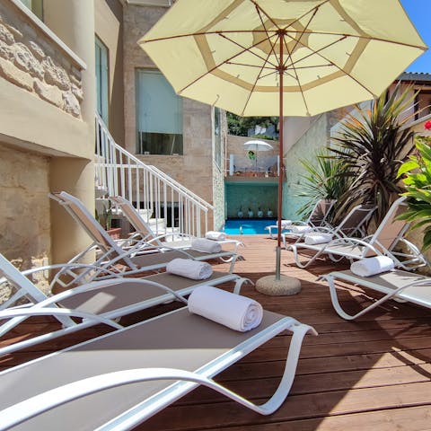 Laze on loungers in the sun or the shade on your private poolside deck