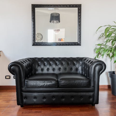 Make yourself at home on the Chesterfield-style sofa