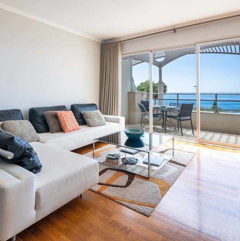 Kick back and relax on the lounge-worthy L-shaped sofa while admiring stunning sea views
