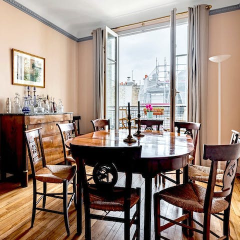 Enjoy family feasts and French wine at the wooden dining table 