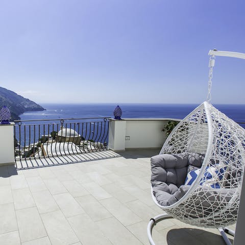 Sit and admire the beautiful ocean from the swinging egg chair on your large terrace