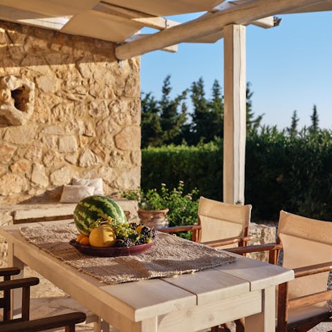 Serve up local Greek delicacies including local olives and wine at the alfresco dining area 