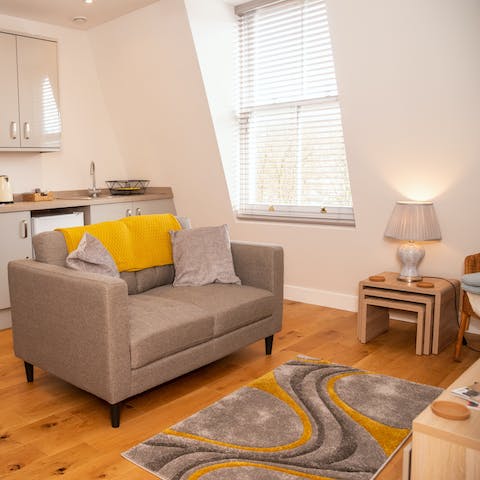 Relax in the bright living area with a glass of wine after a busy day of exploring