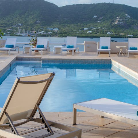 Slip into the pristine swimming pool and look out over the bay