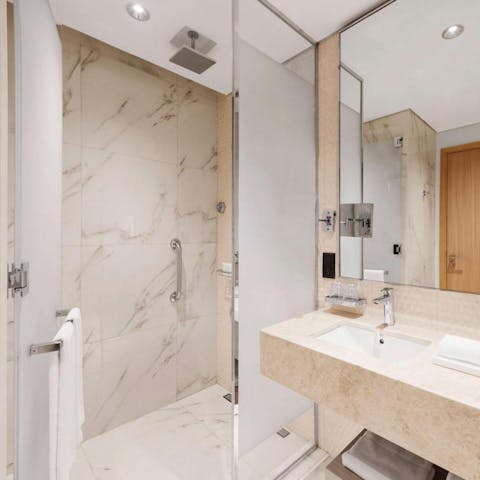 Start mornings with a luxurious soak under the marble-clad bathroom's rainfall shower