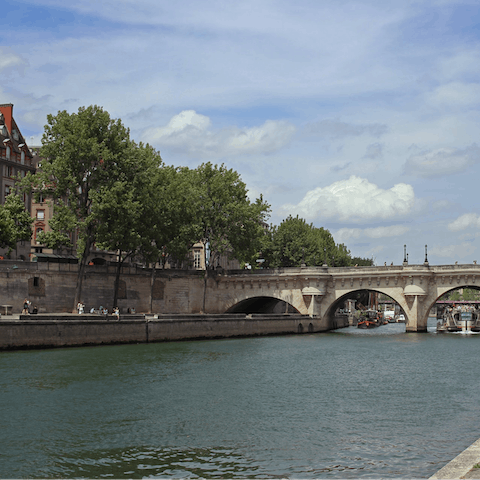 Look out onto the Seine from Pont Saint-Louis, a five-minute walk away