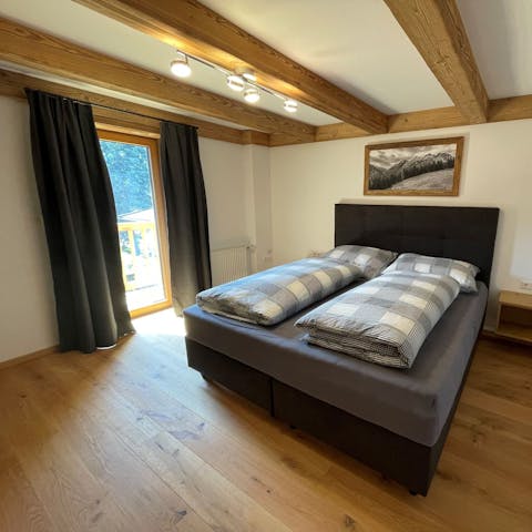 Wake up beneath wood-beamed ceilings and see the Alps from your balcony