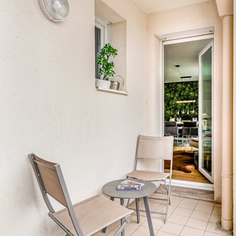 Enjoy a morning coffee on your private balcony, overlooking the city