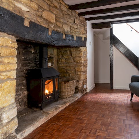 Warm up by the log burning stove in the home's nook