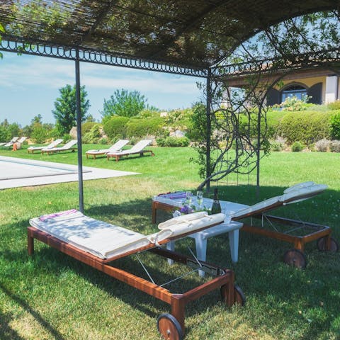 Find a relaxing spot under the pergola to enjoy your holiday book