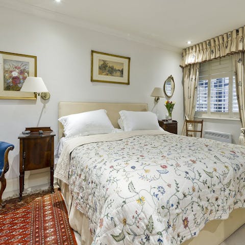 Jump into bed in the elegant bedroom after a long day of exploring the city 