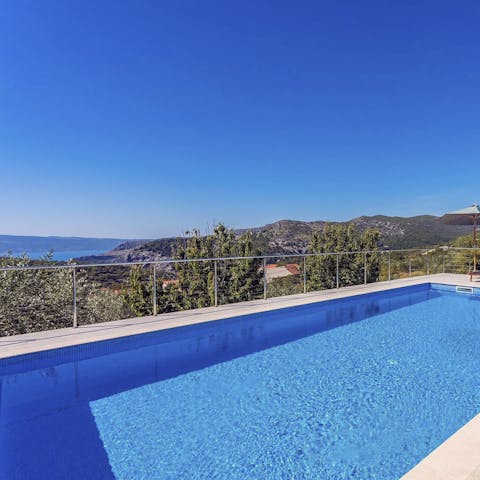 Plunge into the pool and admire the sea views