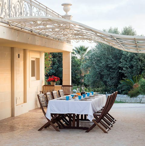 Gather around the alfresco dining set and sip on some Sicilian wine