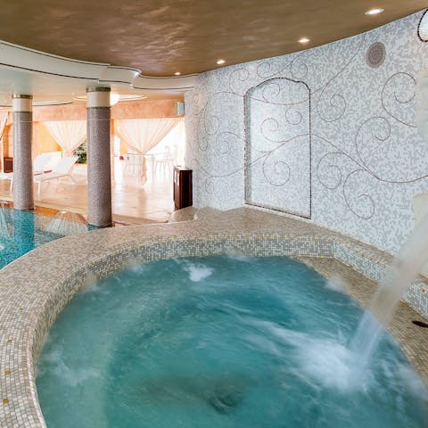 Soak in the lush hot tub and enjoy a back massage from the waterfall