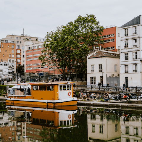 Enjoy a waterside walk along Canal Saint-Martin, just over fifteen minutes away from your apartment on foot