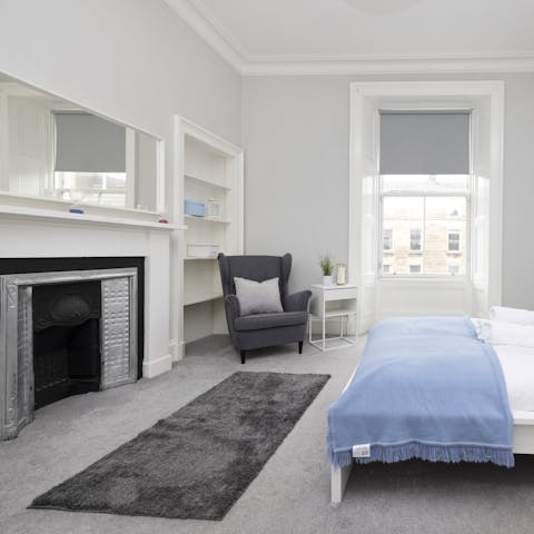 Admire historic tenement touches like the original fireplace in the main bedroom