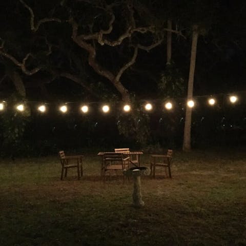Sit under the string lights in the garden  for magical evenings together 