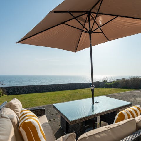 Gaze out at pretty views of Largo Bay while seated around the alfresco dining table