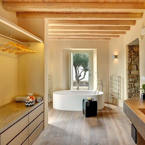 Have a soak in the freestanding bathtub with it's view of an old olive tree