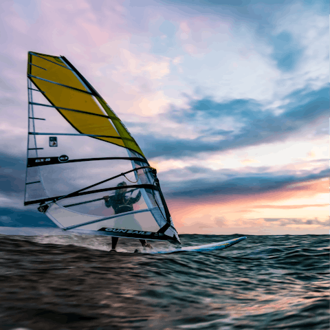 Practise a variety of watersports on the island, including windsurfing 