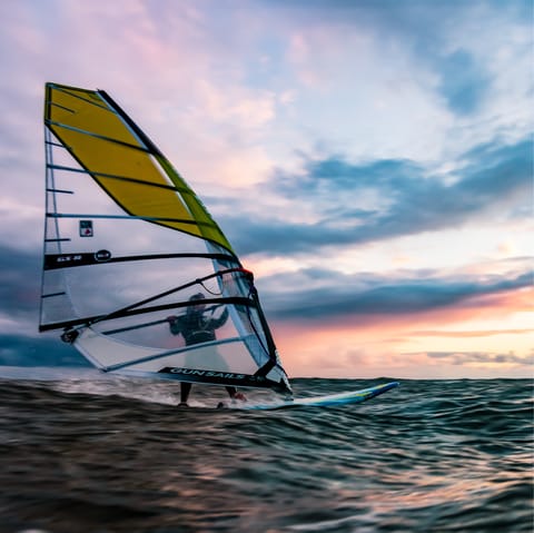 Practise a variety of watersports on the island, including windsurfing