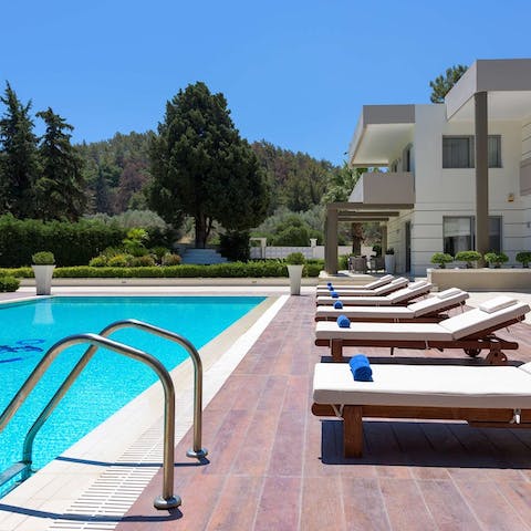 Lounge by the pool and soak up the Greek sunshine