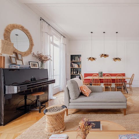 Relax in the stylish living area featuring an ivory piano