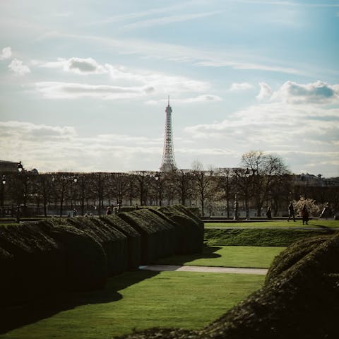 People watch in the Tuileries Garden on a sunny afternoon