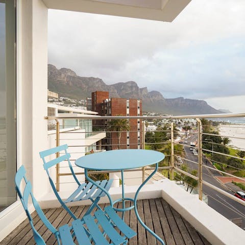 Enjoy the stunning views of Camps Bay Beach from your balcony with a glass of South African wine