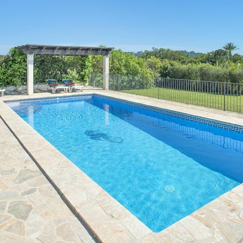 Relax in the shade under the pergola next to the private pool