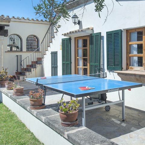 Have a game of table tennis on the patio with its potted plants