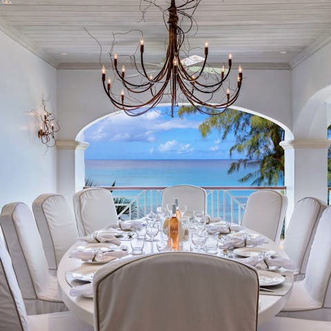 Gather around the elegant table for a memorable feast overlooking the waves