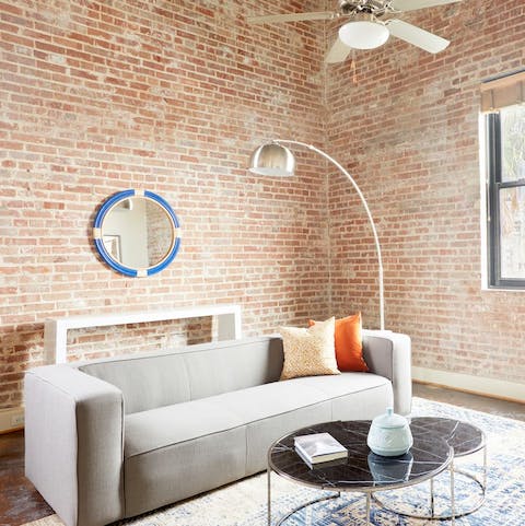 Unwind in the industrial-style living area, with exposed brick and high ceilings